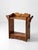 An antique pine washstand featuring a warm honey-brown finish, a scalloped backsplash, and decorative wooden towel bars...