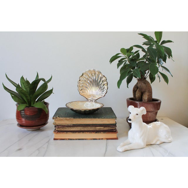 Vintage silver plated clam shell butter dish with frosted glass liner. No makers mark. Does not include butter knife....