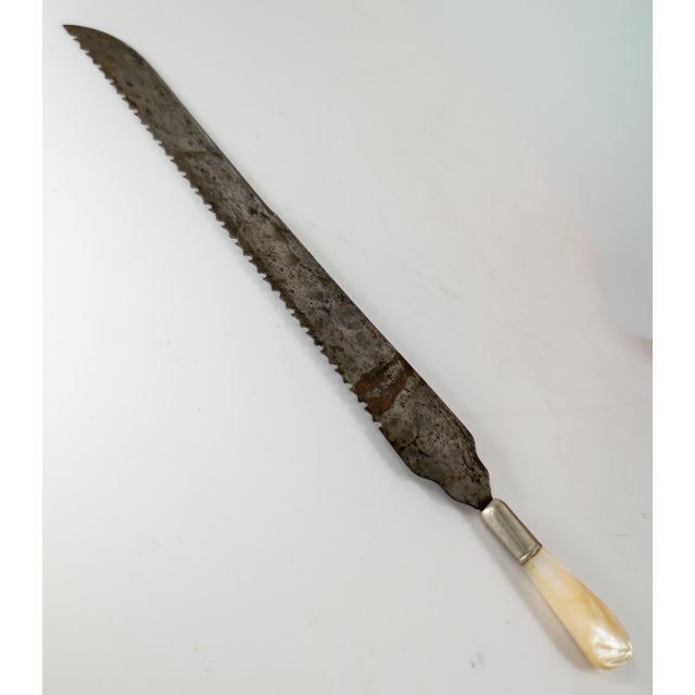 We are selling this really cool 19th Century English Victorian bread knife. This blade has great tooth pattern on a well...