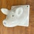 An old ceramic pig head that can be screwed to the wall. Note on back reads "This little Pig Head was made for Jim, he...