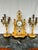 Presenting a breathtaking late 19th-century French Louis XVI-style mantel clock garniture set, crafted from peachy ochre-...