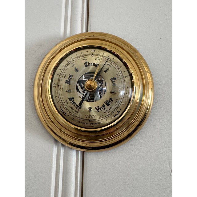 A vintage precision barometer by Vilbor, made in West Germany, featuring a classic brass case and a detailed, easy-to-read...