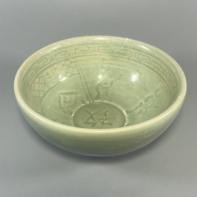 This vintage‑style celadon bowl is coated with smooth green‑toned glaze, with delicate carved ornamentation on the...