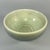 This vintage‑style celadon bowl is coated with smooth green‑toned glaze, with delicate carved ornamentation on the...