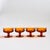A set of 4 gorgeous coupe glasses with a lovely ornate design in amber glass. Made in the King's Crown pattern by Indiana...