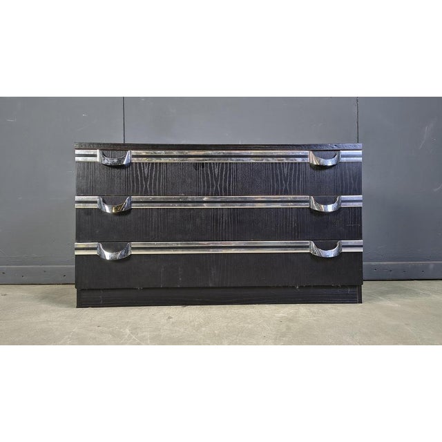 Vintage chest of drawers from the seventies in black ebonized wood with some cool chrome handles. Beautiful seventies...