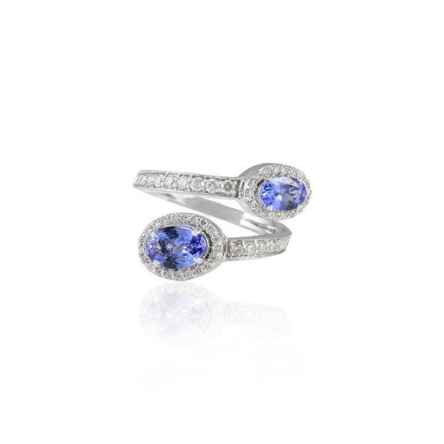 This is part of Chairish’s Fine Jewelry assortment. Genuine Oval Tanzanite and Halo Diamond Bypass Ring Set in 14K Gold...