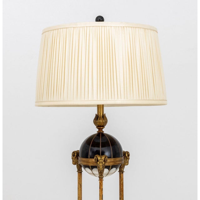 French Empire Revival Ram Head Motif Floor Lamp, with tessellated hardstone globe surrounded by ram's heads and white...