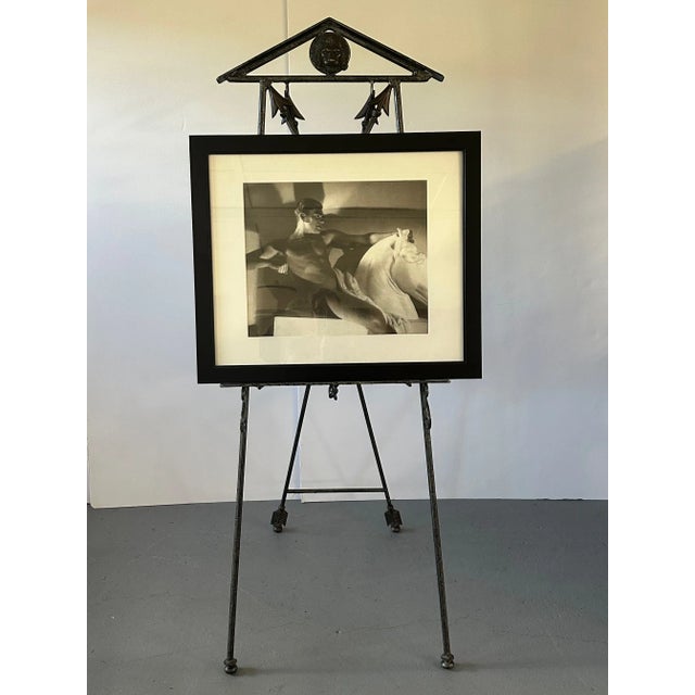 Impressive wrought iron neoclassical style easel with brass accents having arrows, lion heads and beautiful cartouche...