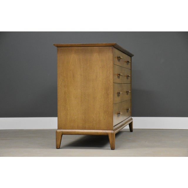 A mid century modern walnut eight drawer dresser made by Henredon Furniture. Original finish in very good condition with...