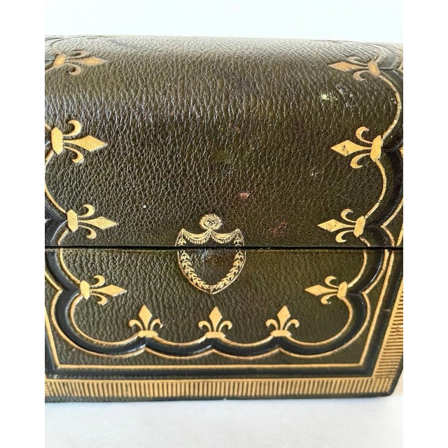 A fabulous antique leather dome top decanter box. A beautiful olive green leather box with amazing gold tooling of lines...
