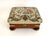 Beautiful wool needlepoint upholstered stool with mahogany base, brass fixtures and resting on four bun feet. The original...