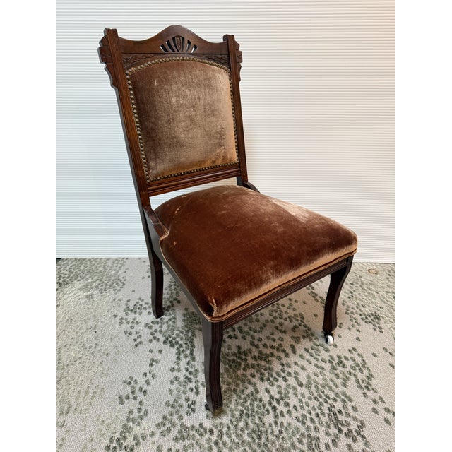 Design Plus Gallery presents a Velvet Side Chair from the Victorian Era. This eastlake style chair has a carved wood frame...