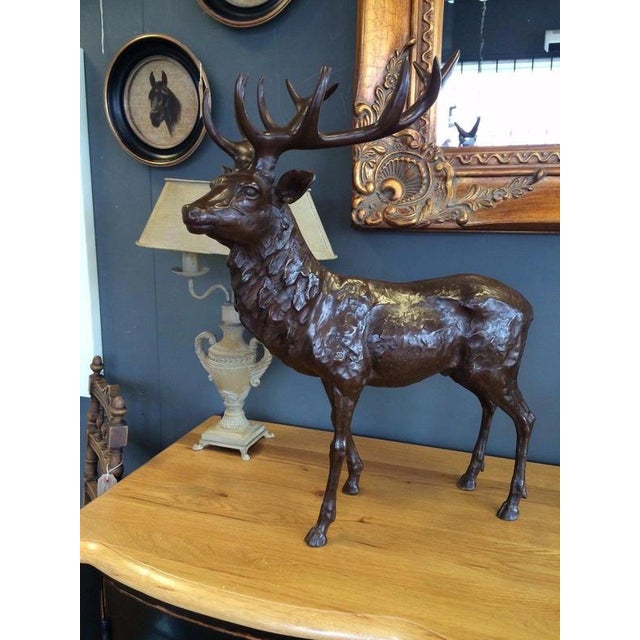 A striking limited-edition stag sculpture. The stag is depicted in a classic proud standing pose, with its head raised and...