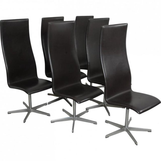 Set of 6 Arne Jacobsen Oxford chairs upholstered in original dark brown essential leather, and with a brushed aluminium...