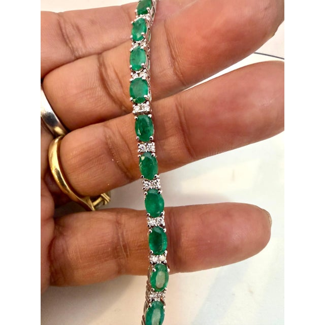 This exceptionally affordable Tennis bracelet has 22 stones of oval Emeralds . Each Emerald is spaced by two diamonds ....