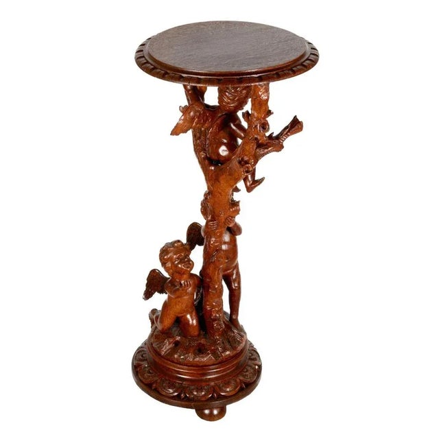 Wooden console with carved cupids frolicking on a tree. They form an original support for the tabletop, the edges of which...