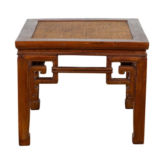 Small antique Chinese Qing Dynasty period elm wood stool from the 19th century with carved scrolling spandrels, woven...