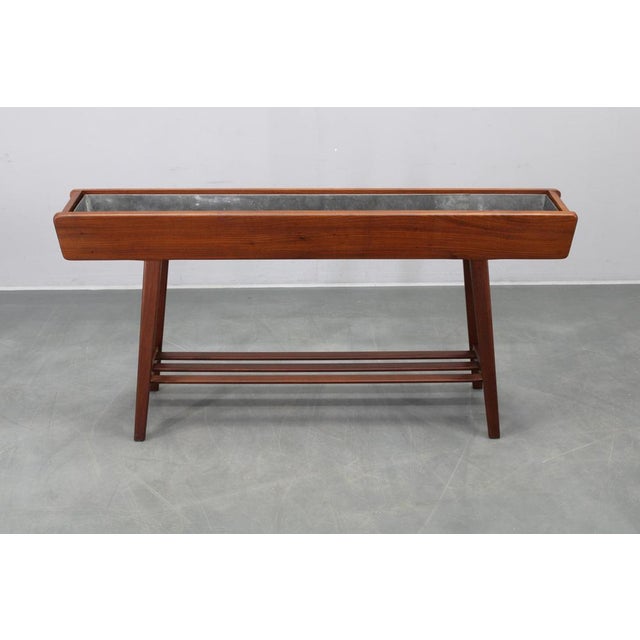 This refined mid-century modern wooden planter box was produced in Denmark during the 1960s. Crafted from solid pine wood...