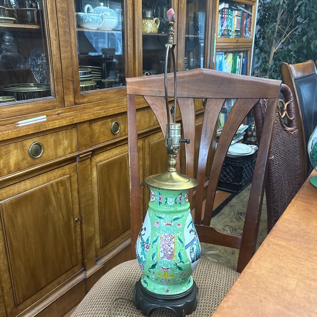The item pictured is a 20th-century Chinese Canton enamel vase that has been converted into a lamp, likely dating from the...