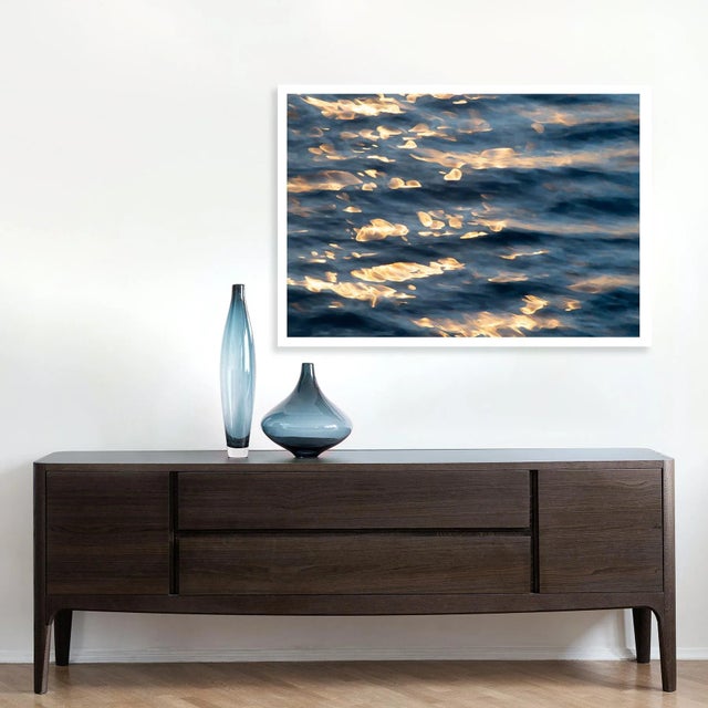 This contemporary photography art print captures gold highlights on the surface of the sea, at the end of the day. Pacific...