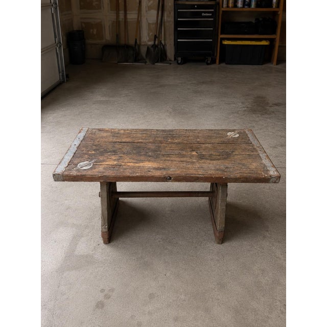 Antique ship hatch door turned into a table on a custom steel base, this is a 2 piece table, the bolts go through the top...