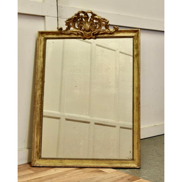 French faded pale gilt Pier mirror The mirror has a very elaborate large pierced top decoration which hangs over the...