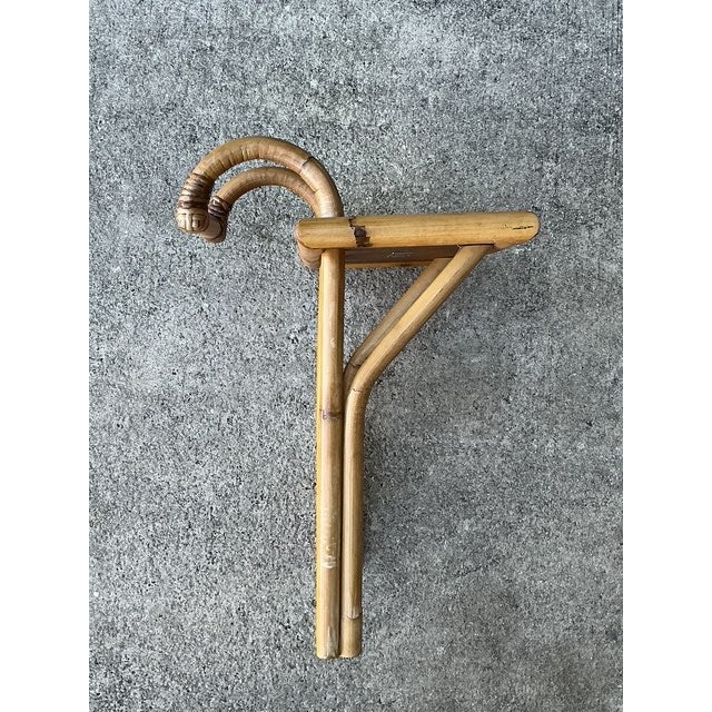 Expertly crafted by the iconic Bielecky Brothers, this vintage rattan hook-on side table is a masterclass in functional...