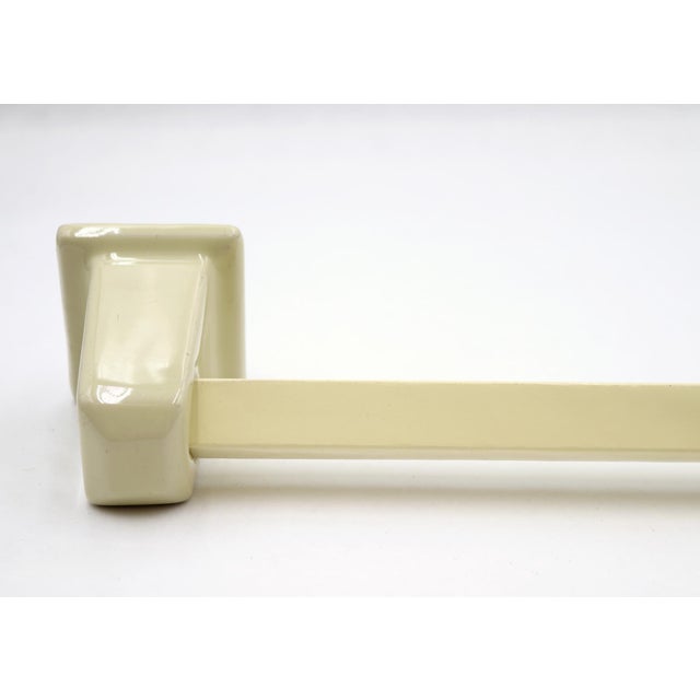 Reclaimed vintage flush mount yellow towel bar made of a ceramic bracket and plastic wrapped wooden square bar. The...