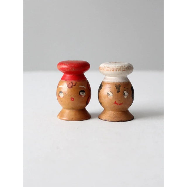 This is a pair of vintage wooden salt & pepper shakers circa 1950. Cheeky, hand-painted chefs faces with hats shape the...