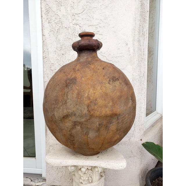 Rare, Large leather organic antique pot with wooden cap. The muted natural color makes it very decorative. Measures 27H x...