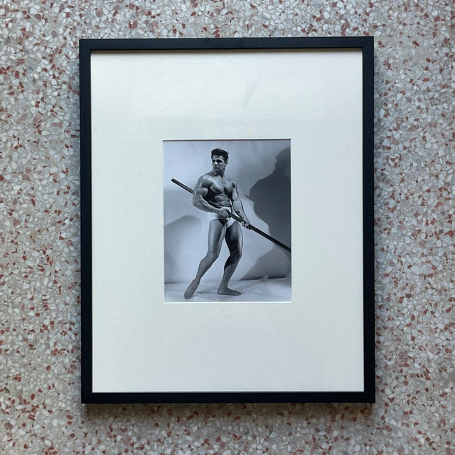 This striking Mid 20th Century Vintage Bruce of LA Framed Photograph captures the powerful elegance of the human form,...