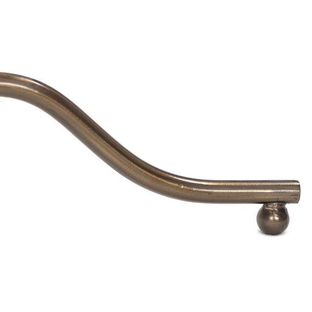 A dark brass base contrasts a smooth garnet marble top with heavy veining for added movement.