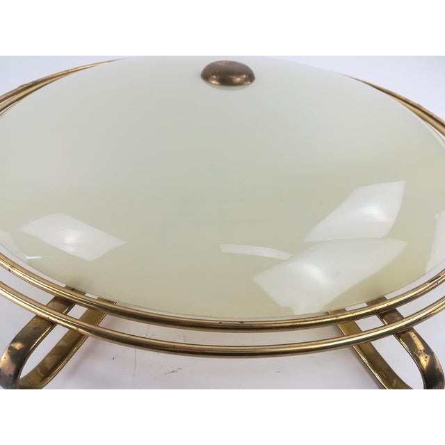 Brass ceiling lamp in original condition with tinted glass shade. Diameter 67 cm. Rewired according to today's security...