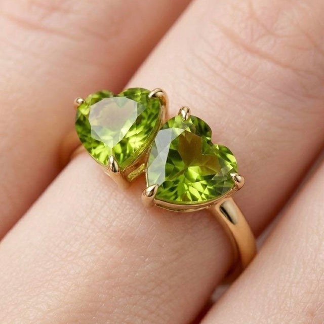 Celebrate love and vibrant elegance with this exquisite Dual Heart Peridot Ring, a beautifully crafted piece that...
