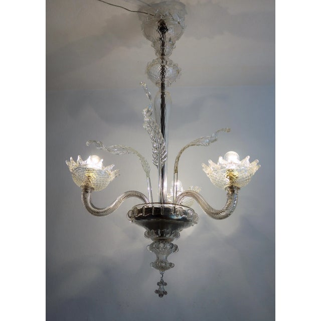 Beautiful true vintage chandelier with up-going arms and light bulbs inside beautifully handcrafted glass bowls. Made in...
