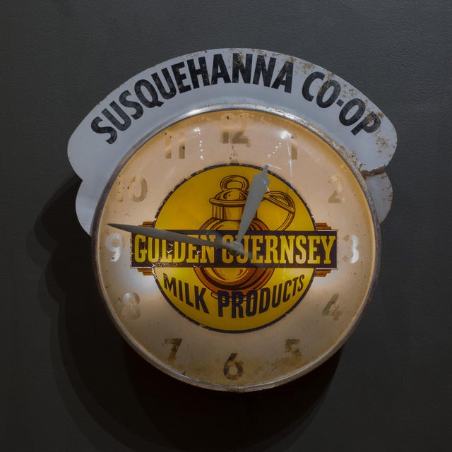 ABOUT An original illuminated "Golden Guernsey Milk Products" advertising wall clock with a metal topper "Susquehanna Co-...