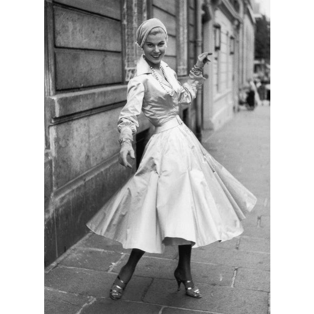 Cocktail Dress 4th September 1954: A cocktail dress and waist length fitted jacket in cream satin made by Jacques Fath....