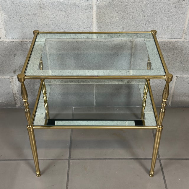 An icon of Parisian style and refinement to enhance your spaces. This rare and elegant brass and crystal side table,...