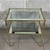 An icon of Parisian style and refinement to enhance your spaces. This rare and elegant brass and crystal side table,...