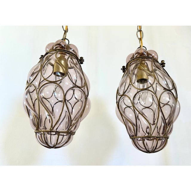 Pair vintage Venetian glass caged glass lanterns in pale lavendar or lilac colored glass. Shaped glass and wire frame...