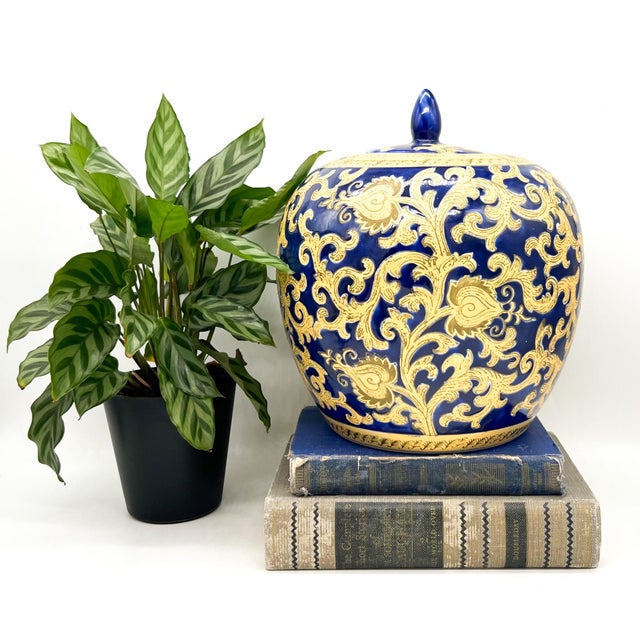Charming, vintage lidded ginger jar in a rich cobalt blue glaze with elaborate gilt scrolling floral decoration. A lovely...