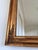 A 19th-century French wall mirror in Napoleon III style. This large mirror features a rectangular giltwood frame with...
