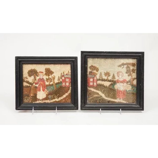 Pair antique needlework pictures each showing a young girl in a country landscape. Wonderful composition, color and...