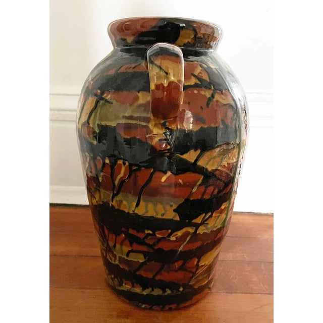 Large vintage terra cotta uitn with handles amd drip glaze finish. Please note:There has been a repair to one handle...