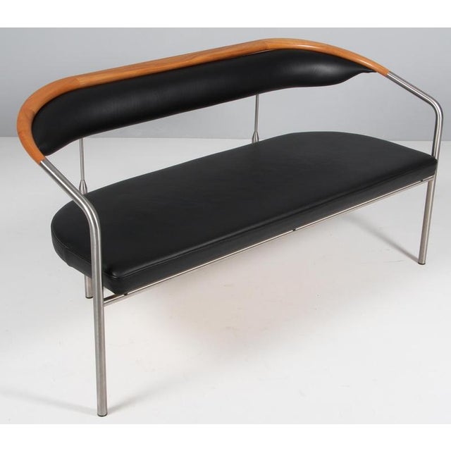 Henrik Tengler sofa in steel and backrest of walnut. Upholstered with black leather. Made by Hansen & Sørensen. This piece...