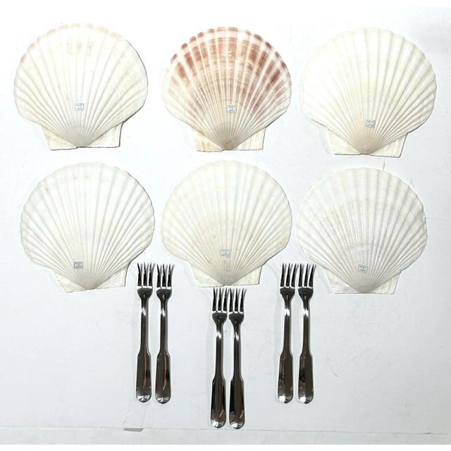 A coastal 1970s appetizer set with six large natural seashell plates and six original stainless steel forks. The...