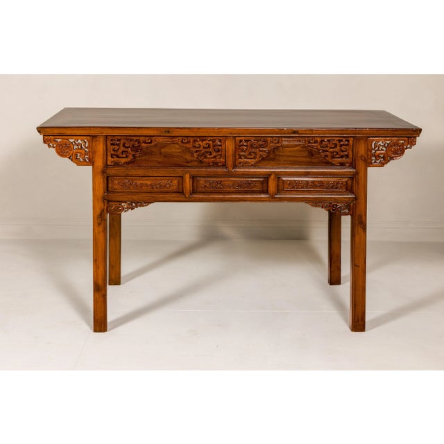 A richly carved console table with two drawers, scrolling clouds and flowers. An exquisitely detailed masterpiece, this...