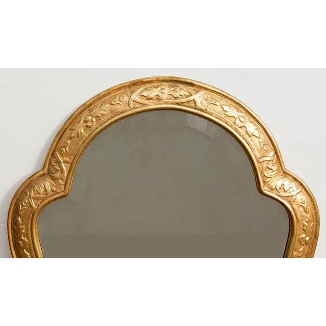 Carved and gilt beveled glass mirror. In the Moresque style. Please, contact us for shipping options