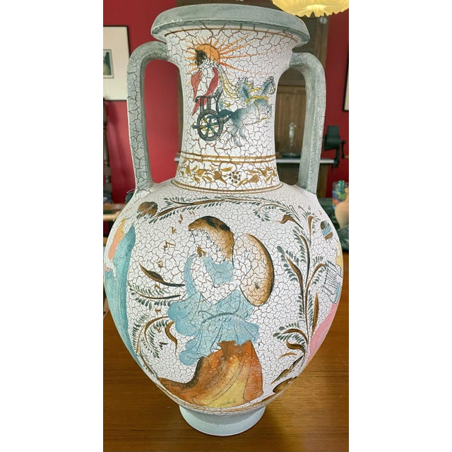 This white based-vase has a crackled polychrome design of turquoise, orange, red, and green is a copy by the Union of...